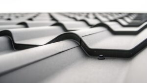 Close-up view of a metal roof with wavy design and rivets showing material detail